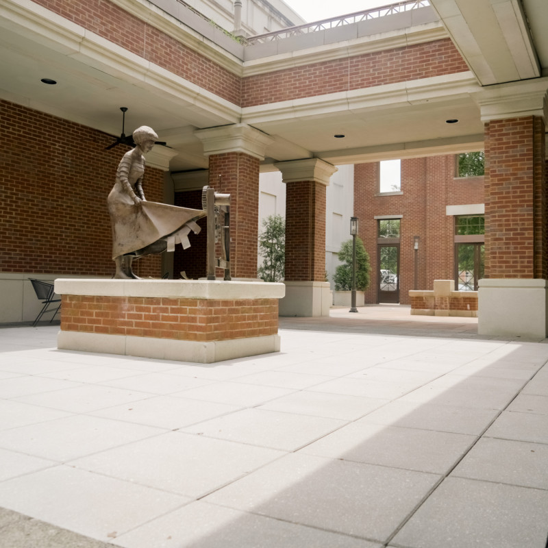 red brick courtyard with statue of girl