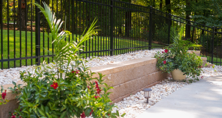 black iron rod fence with planters