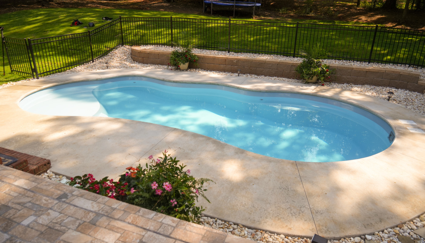 pool with black iron rod fence