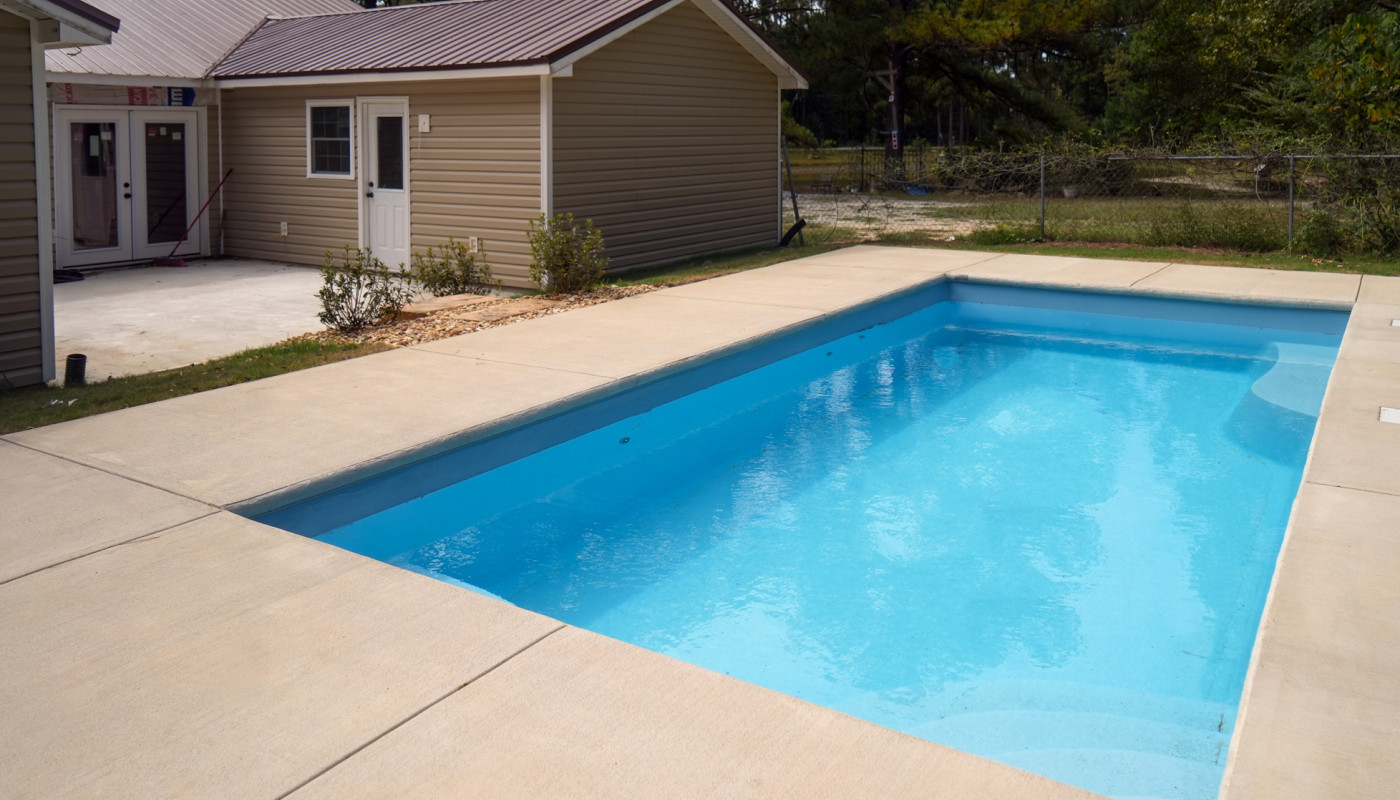 rectangle pool with poured patio